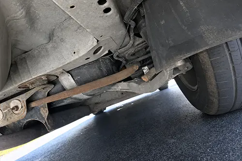 Car Sits Lower on One Corner After Parking: Spring Sag, Binding Shock, or Uneven Load Path?